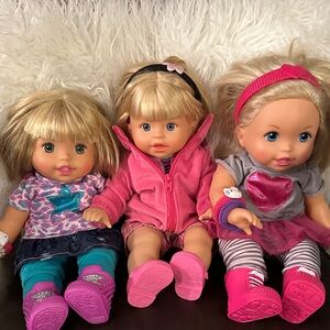 Charming Blonde Doll Trio with Pink and Blue Outfits